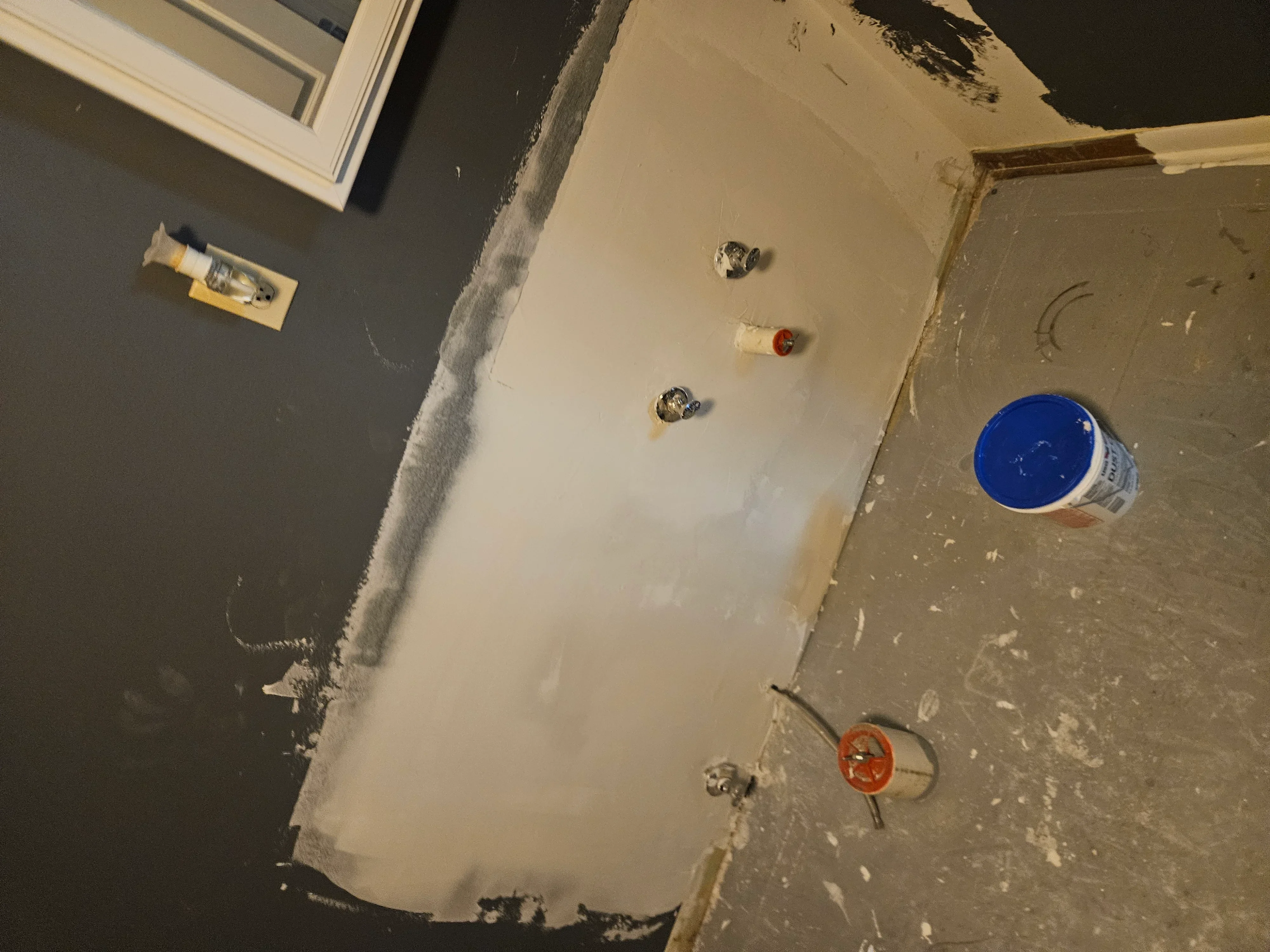 Drywall ceiling and wall installation with taped seams, electrical boxes, and joint compound application