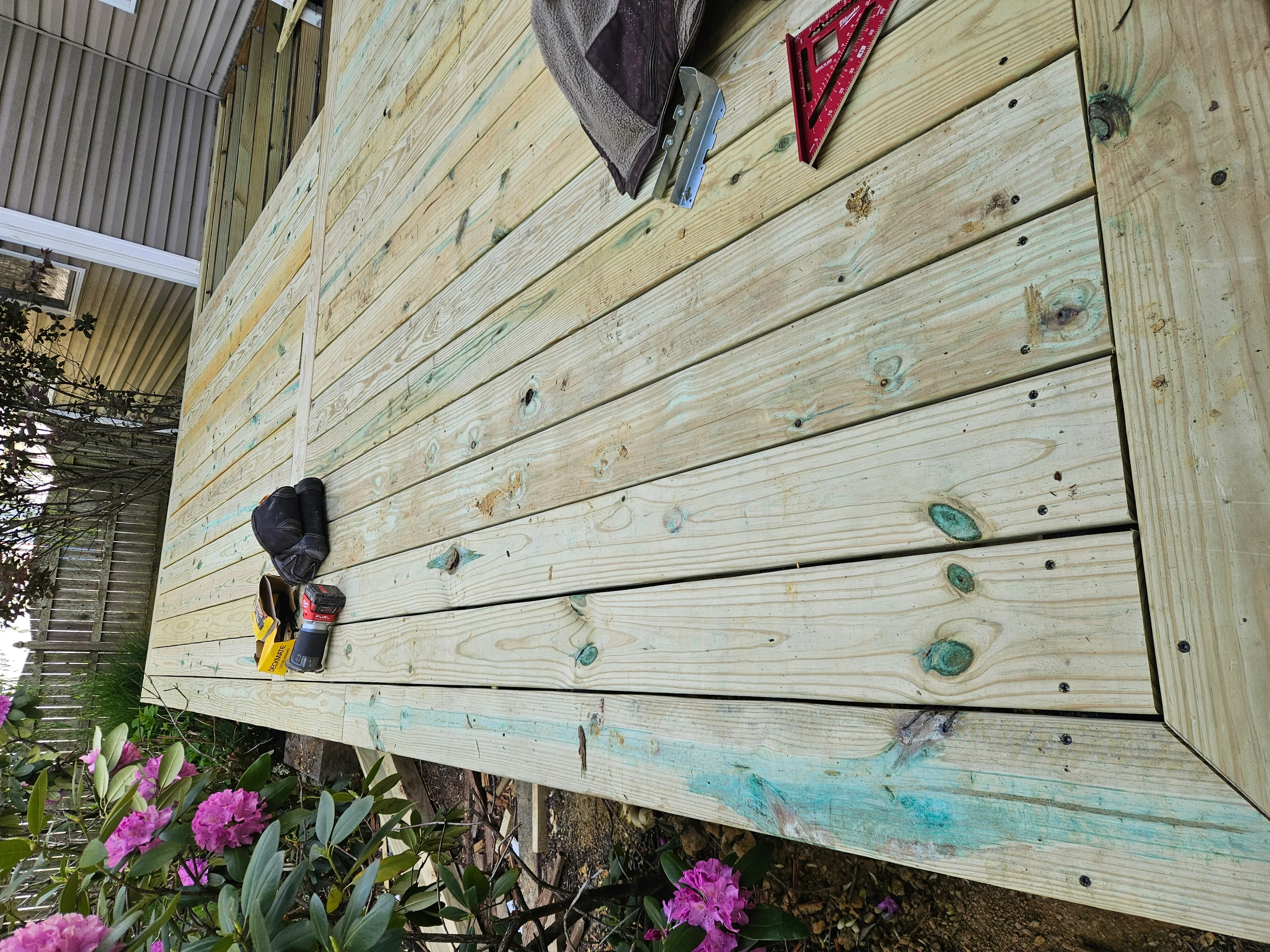 Pressure-treated horizontal deck boards with fasteners, new and existing wood installation